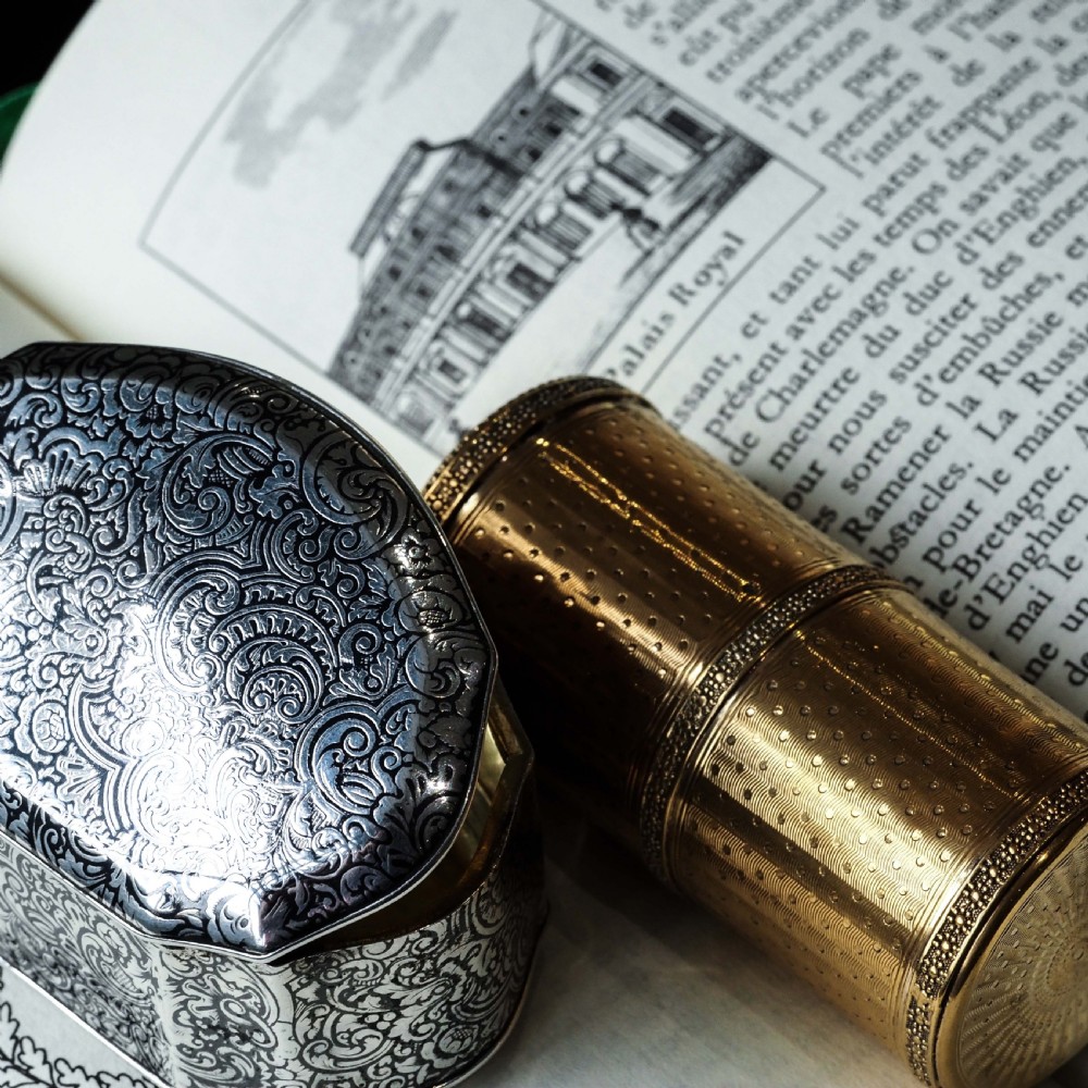 An antique French solid silver snuff box with black niello scrollwork engraving and a gilded gold interior. View XXVII