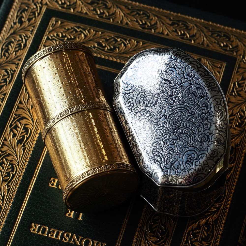 An antique French solid silver snuff box with black niello scrollwork engraving and a gilded gold interior. View XXIX