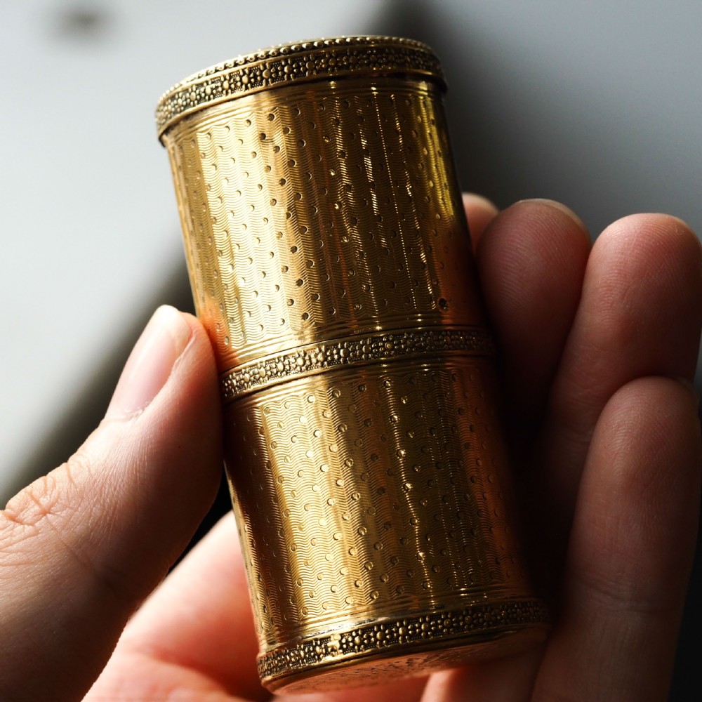 A small cylindrical French silver gilt etui featuring intricate engine-turned guilloche wave patterns and textured borders. View II