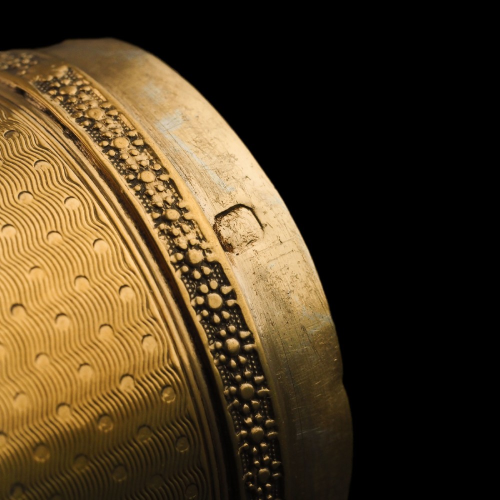 A small cylindrical French silver gilt etui featuring intricate engine-turned guilloche wave patterns and textured borders. View VII