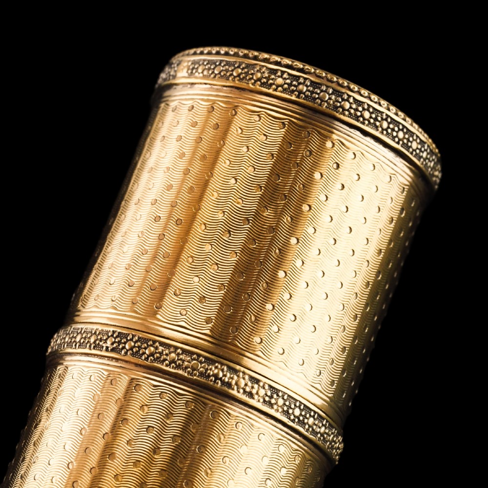 A small cylindrical French silver gilt etui featuring intricate engine-turned guilloche wave patterns and textured borders. View XI