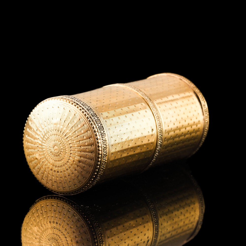 A small cylindrical French silver gilt etui featuring intricate engine-turned guilloche wave patterns and textured borders. View XVII