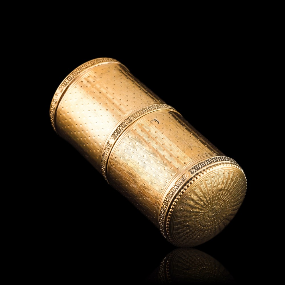 A small cylindrical French silver gilt etui featuring intricate engine-turned guilloche wave patterns and textured borders. View XVIII