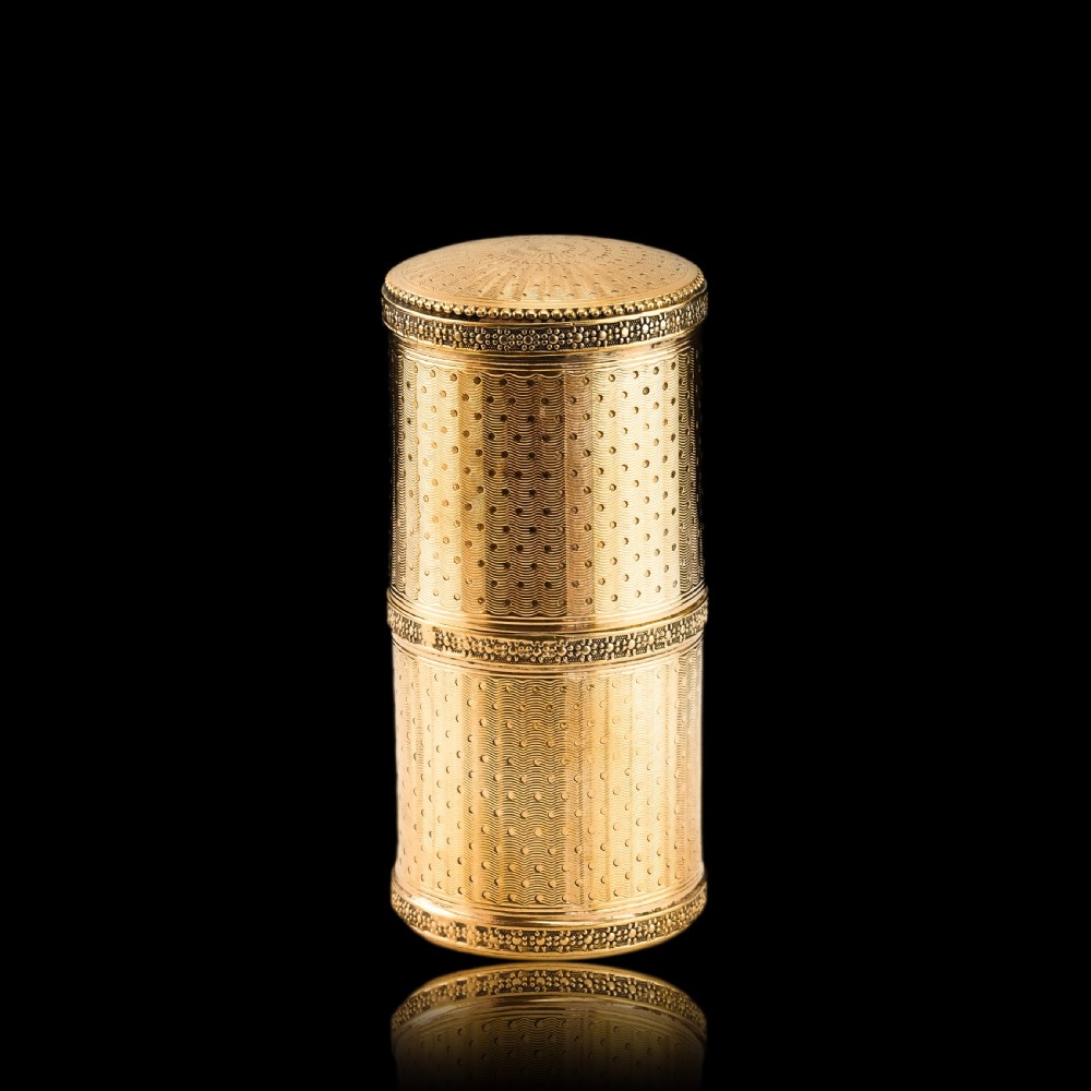 A small cylindrical French silver gilt etui featuring intricate engine-turned guilloche wave patterns and textured borders. View XX