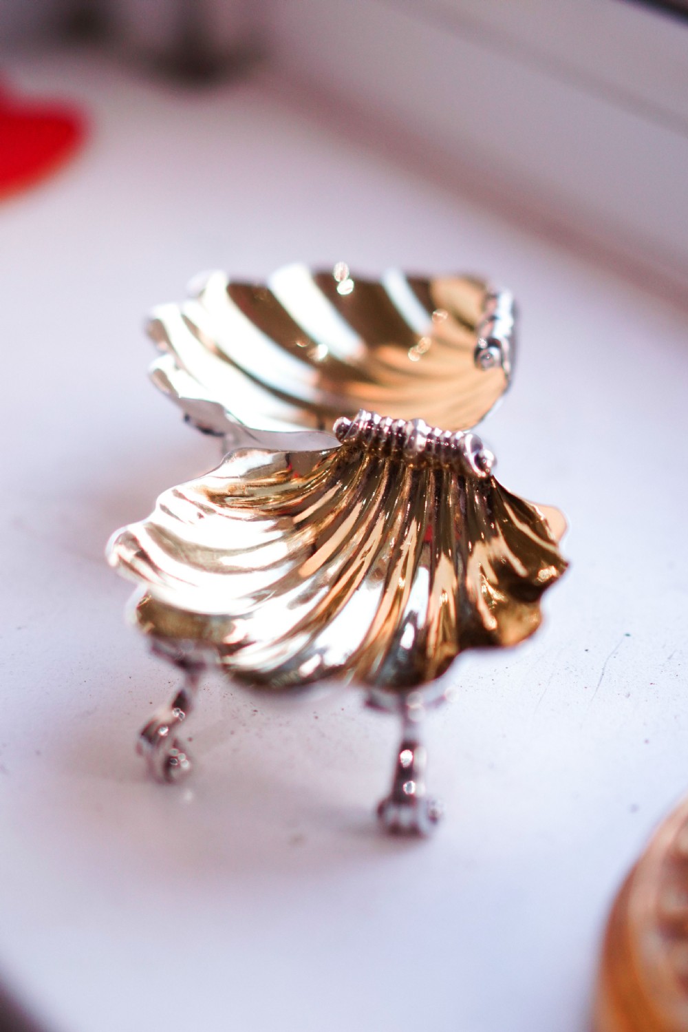 A pair of Georgian sterling silver salt cellars shaped like fluted scallop shells with gilt interiors. View II