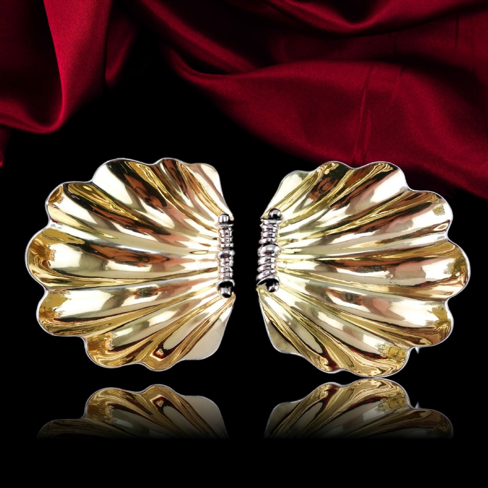 A pair of Georgian sterling silver salt cellars shaped like fluted scallop shells with gilt interiors. View III