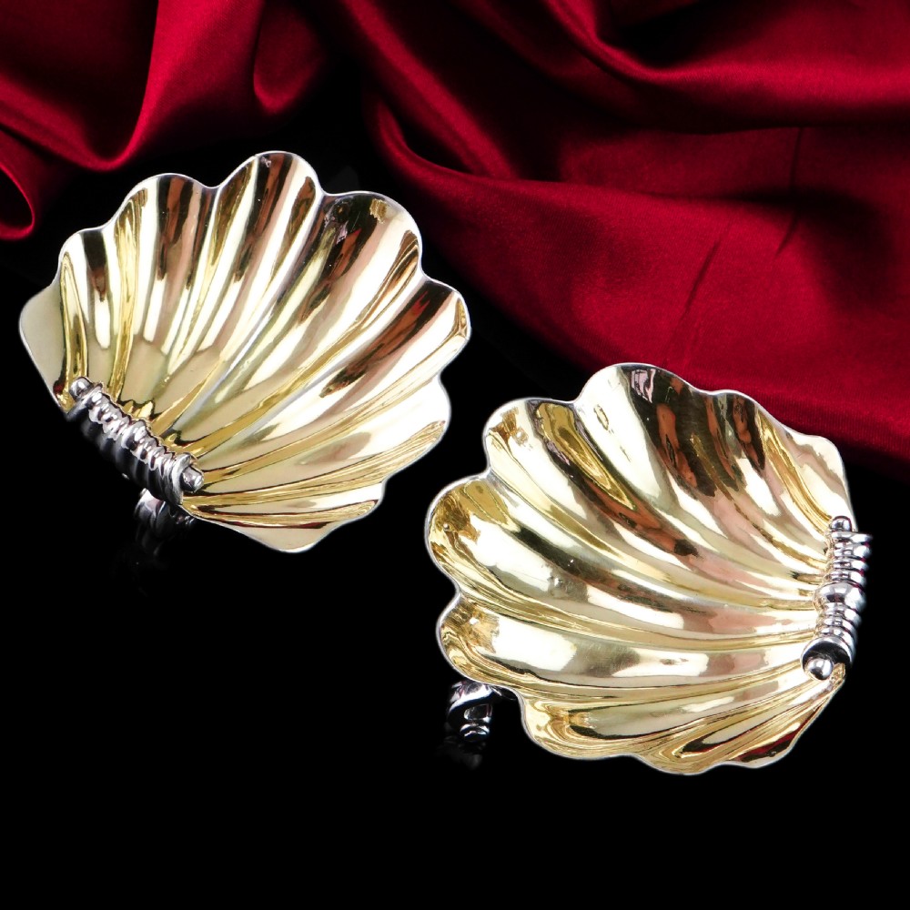A pair of Georgian sterling silver salt cellars shaped like fluted scallop shells with gilt interiors. View VII