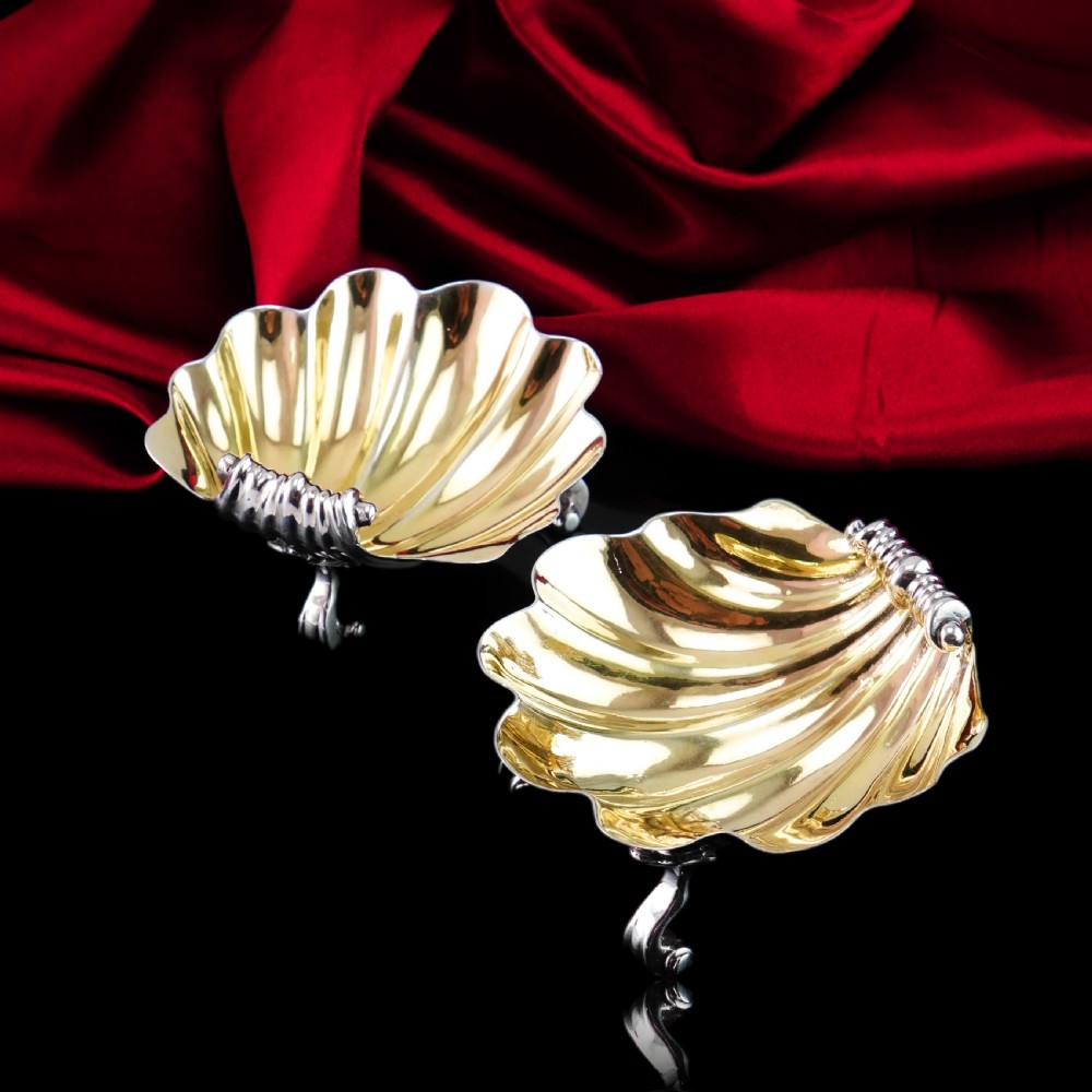 A pair of Georgian sterling silver salt cellars shaped like fluted scallop shells with gilt interiors. View VIII