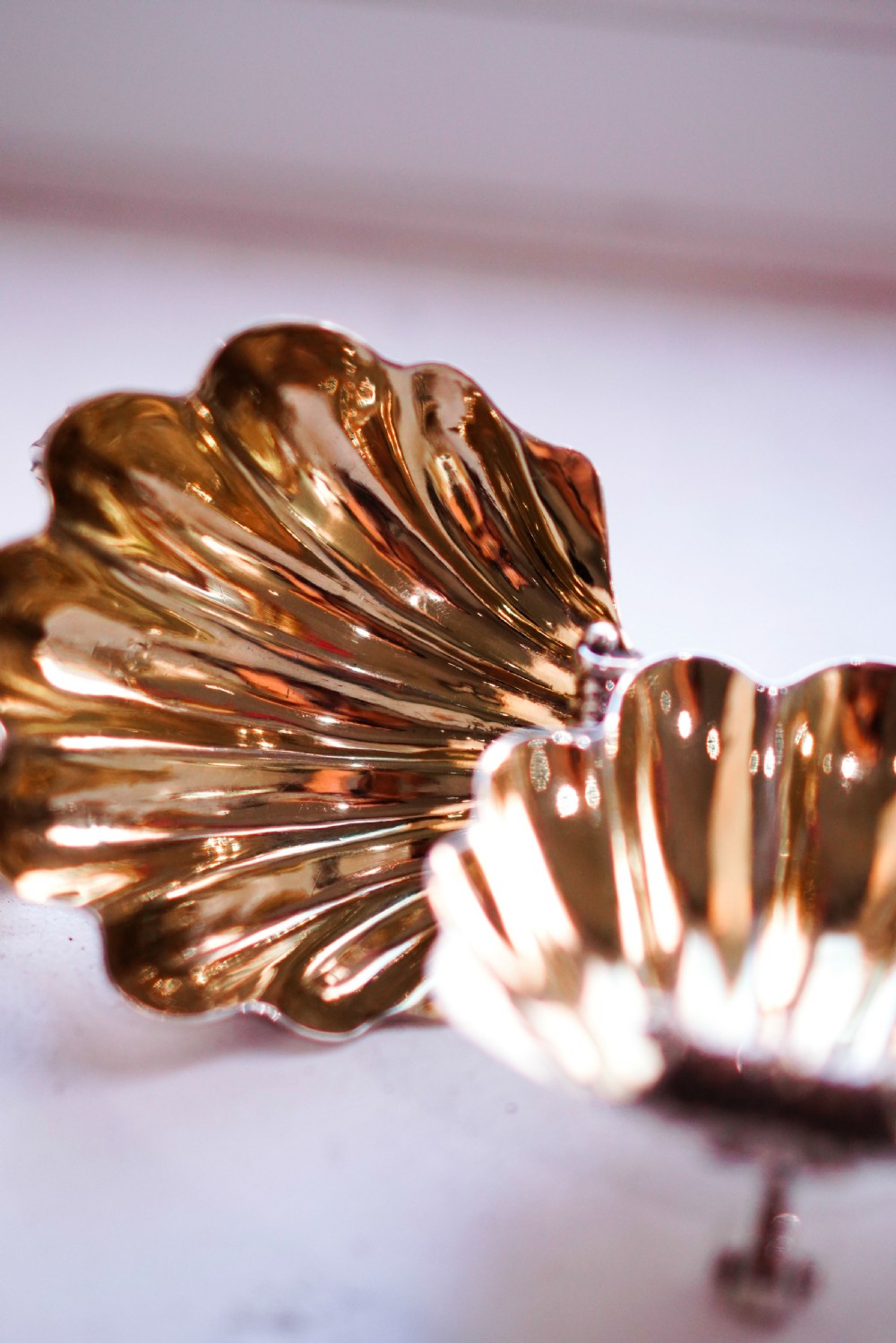 A pair of Georgian sterling silver salt cellars shaped like fluted scallop shells with gilt interiors. View IX