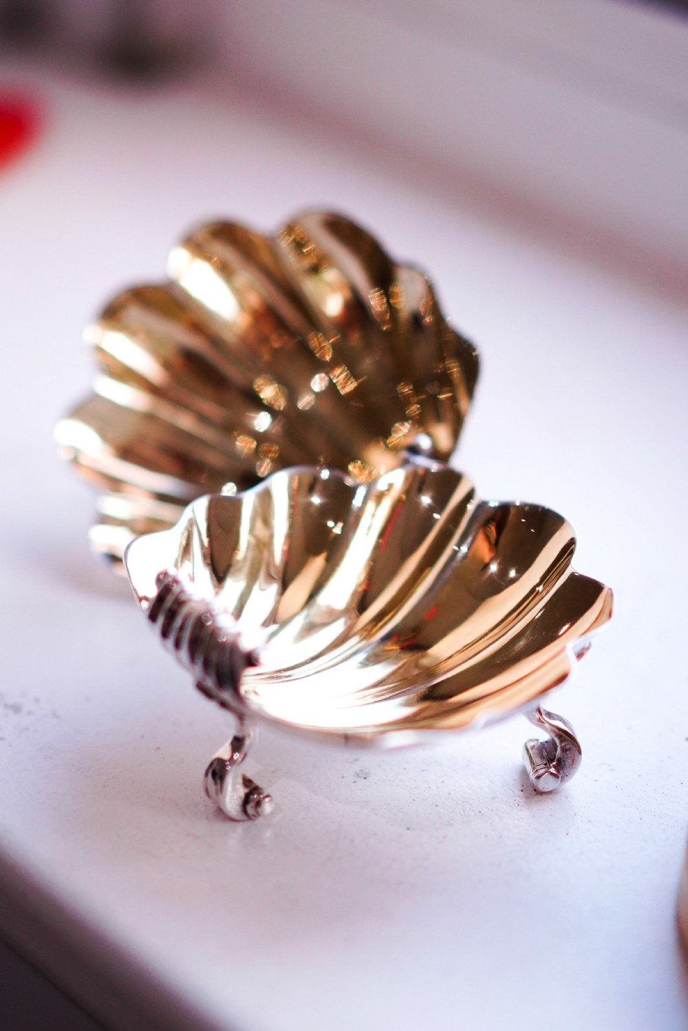 A pair of Georgian sterling silver salt cellars shaped like fluted scallop shells with gilt interiors. View X