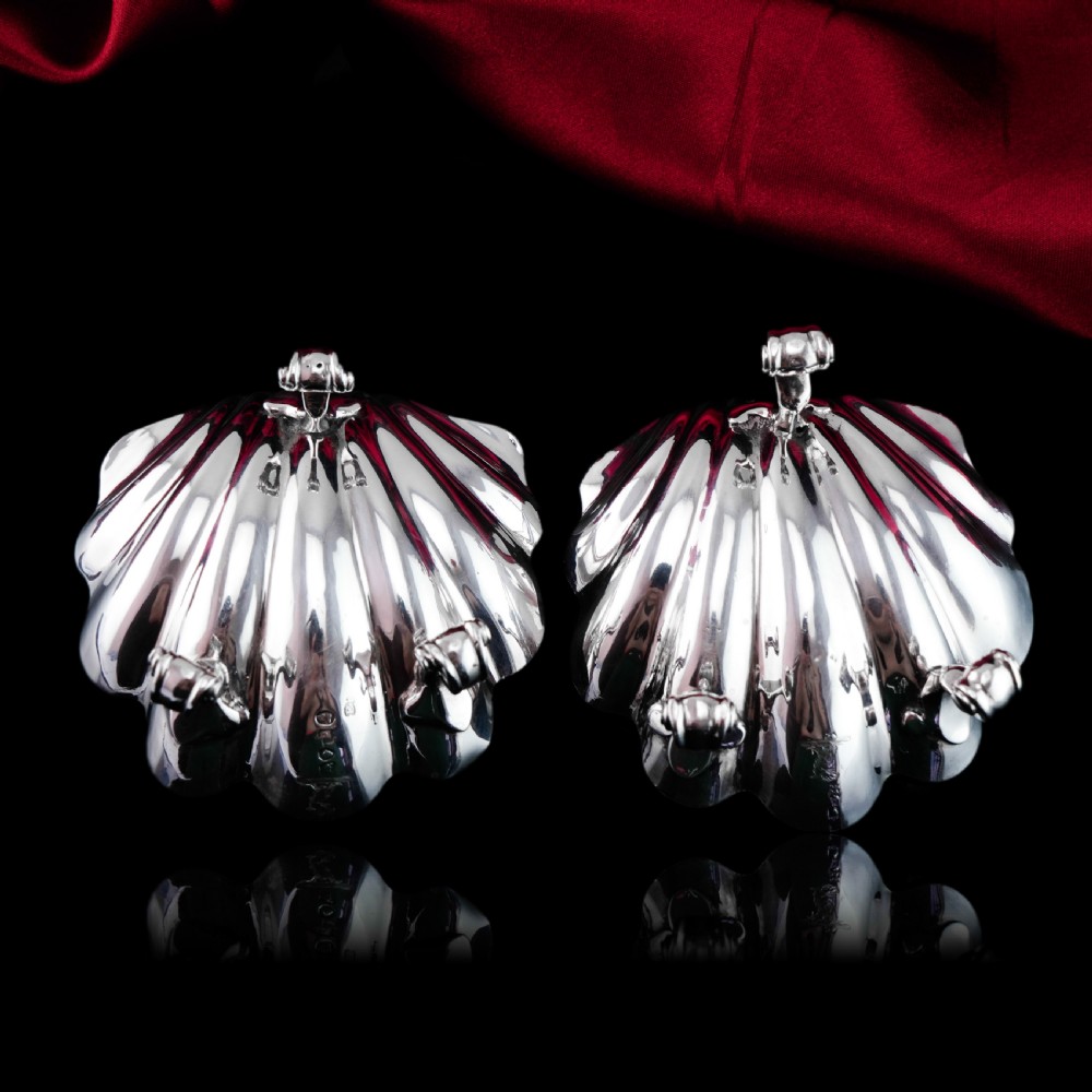 A pair of Georgian sterling silver salt cellars shaped like fluted scallop shells with gilt interiors. View XV