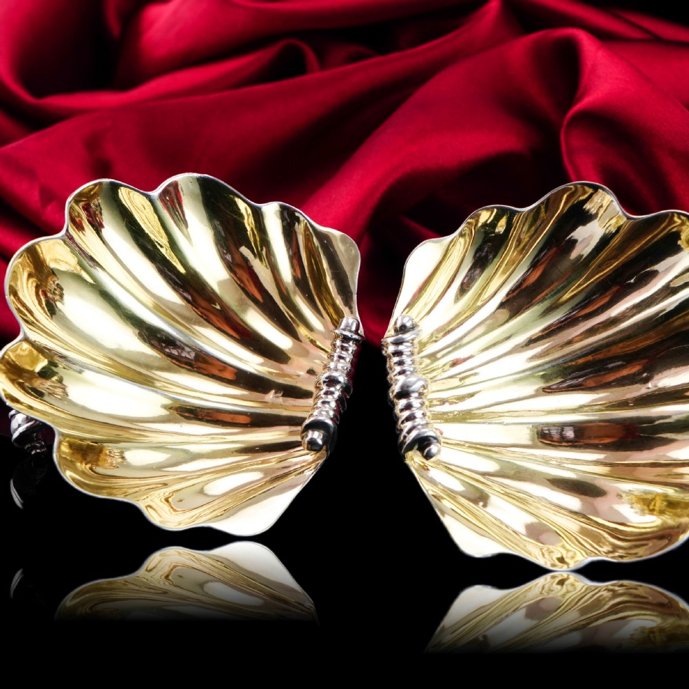 A pair of Georgian sterling silver salt cellars shaped like fluted scallop shells with gilt interiors. View XXII