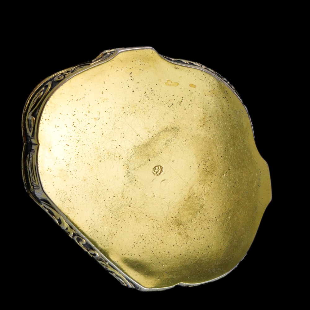 An eighteenth-century shaped oval silver-gilt table snuff box featuring Rococo scrollwork and a raised mythological scene on the hinged lid. View XIII