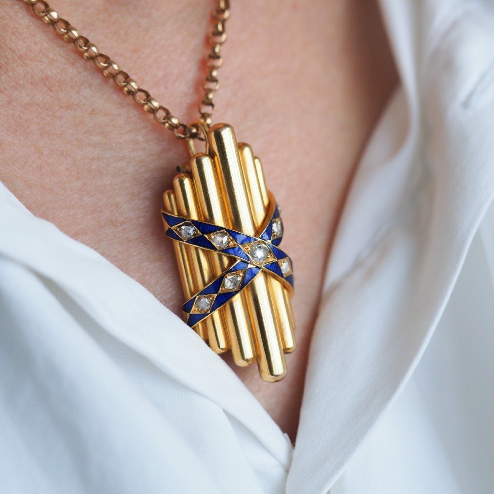 A Victorian 18K yellow gold pendant featuring vertical fluted bars encased by blue enamel cross-bands set with rose-cut diamonds. View II