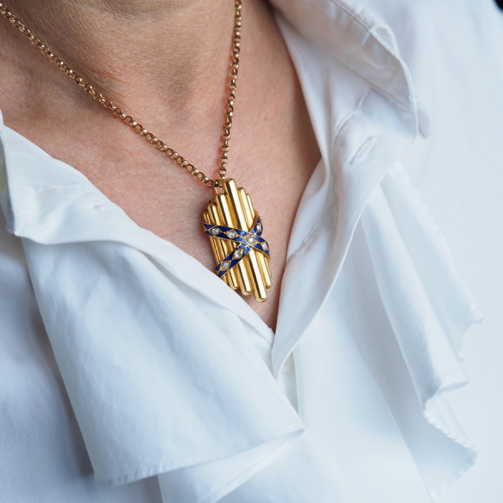 A Victorian 18K yellow gold pendant featuring vertical fluted bars encased by blue enamel cross-bands set with rose-cut diamonds. View III