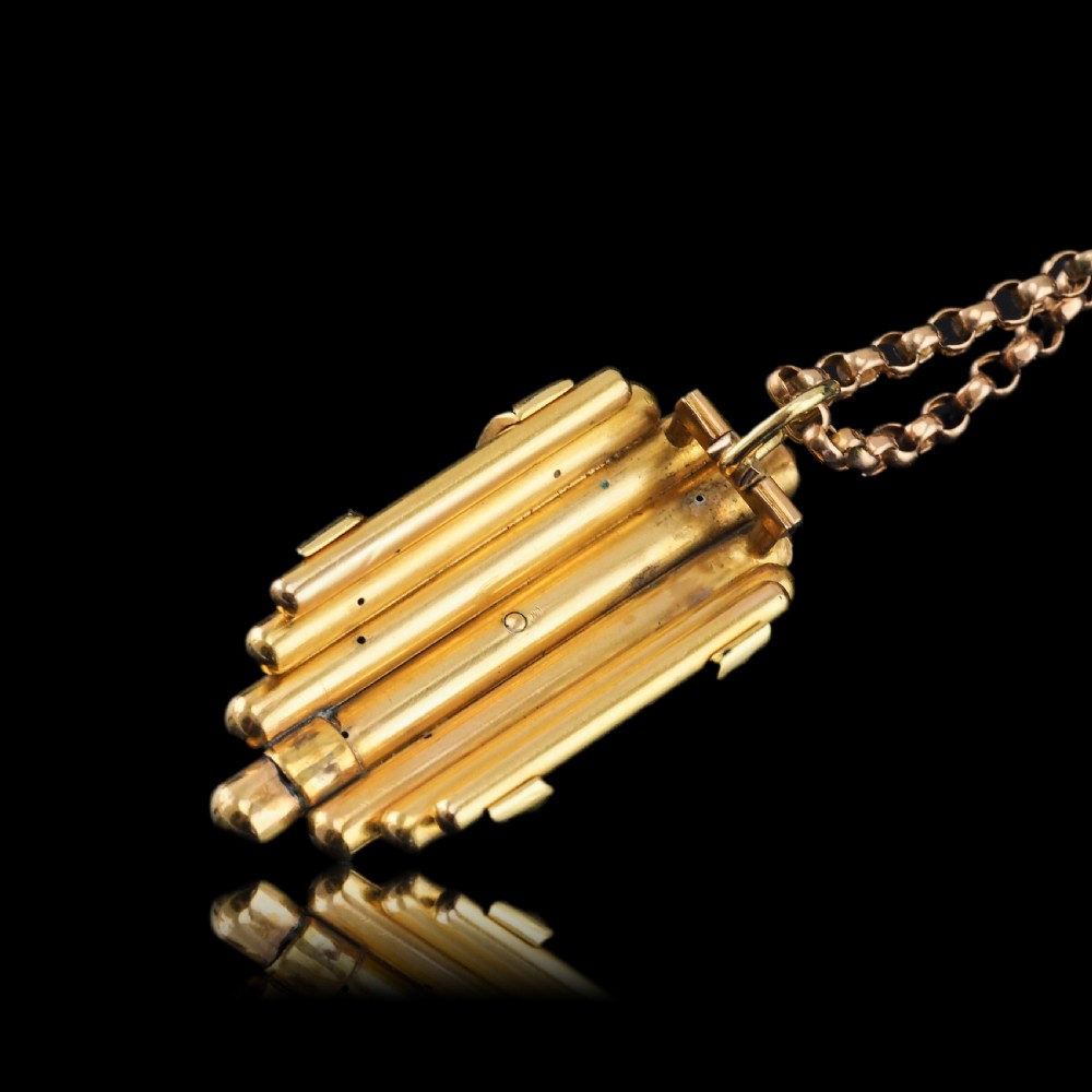 A Victorian 18K yellow gold pendant featuring vertical fluted bars encased by blue enamel cross-bands set with rose-cut diamonds. View XVIII