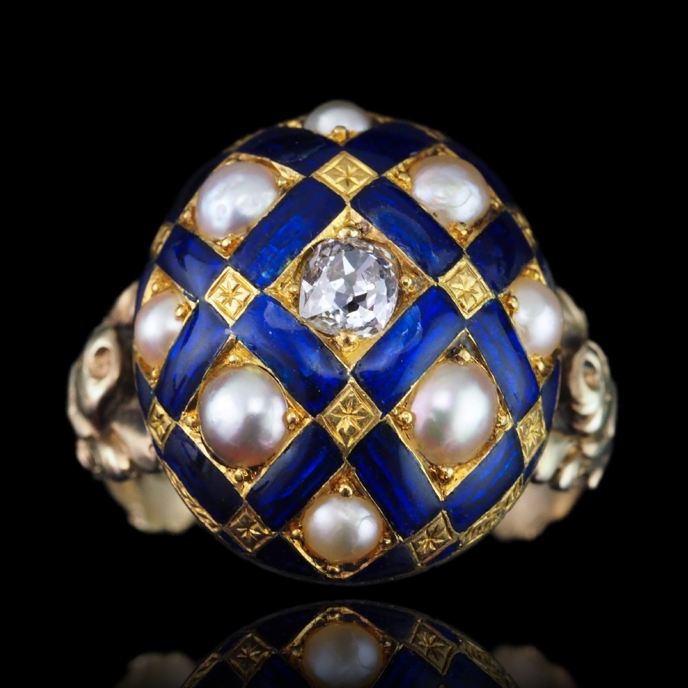 An antique Victorian 14K gold ring featuring a domed royal blue enamel lattice design accented with round pearls, star engravings, and a central diamond. View II