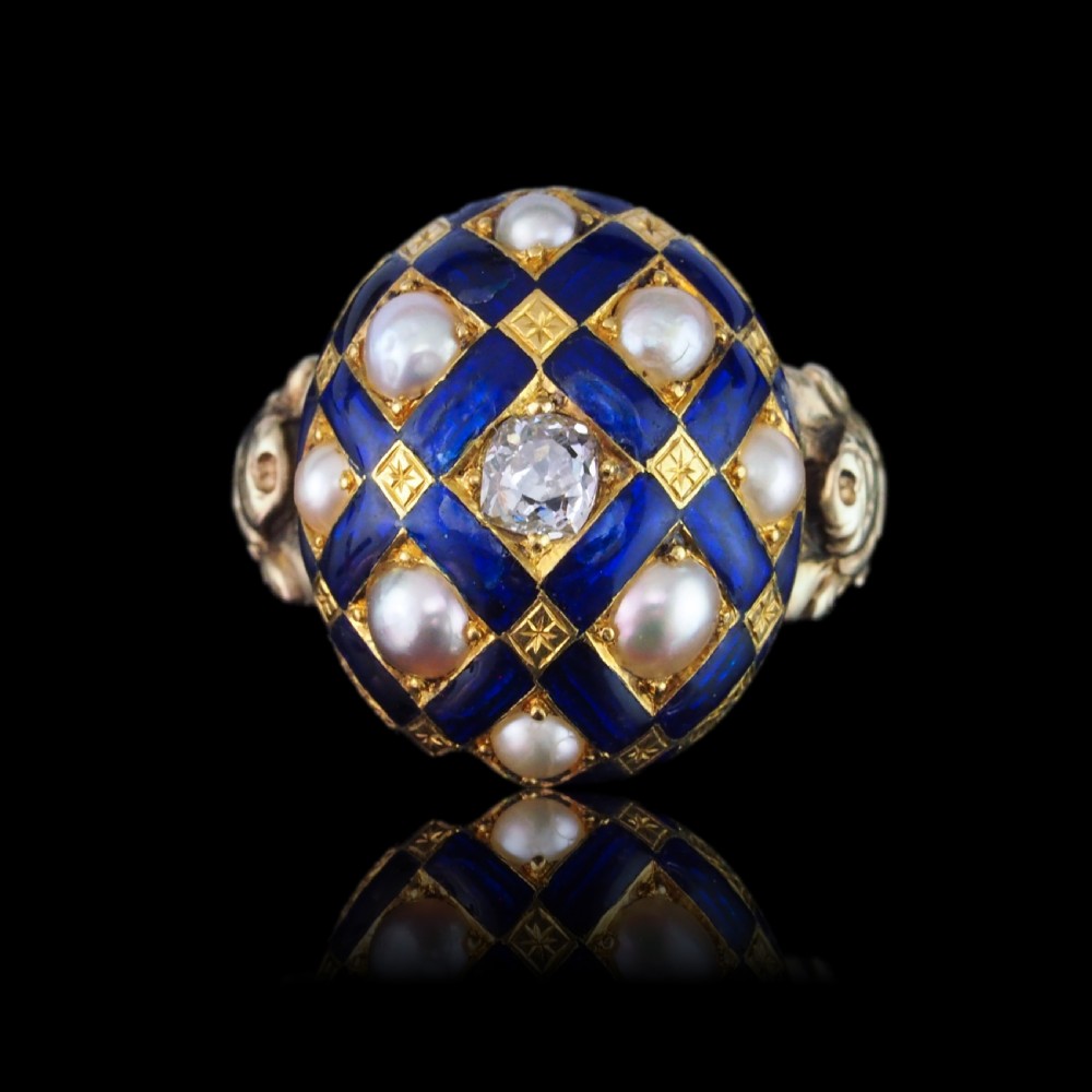 An antique Victorian 14K gold ring featuring a domed royal blue enamel lattice design accented with round pearls, star engravings, and a central diamond. View VI