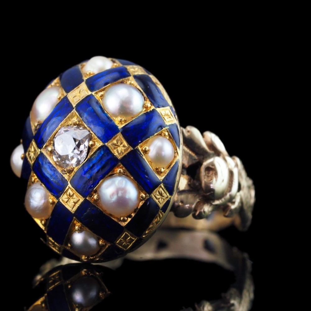 An antique Victorian 14K gold ring featuring a domed royal blue enamel lattice design accented with round pearls, star engravings, and a central diamond. View XI