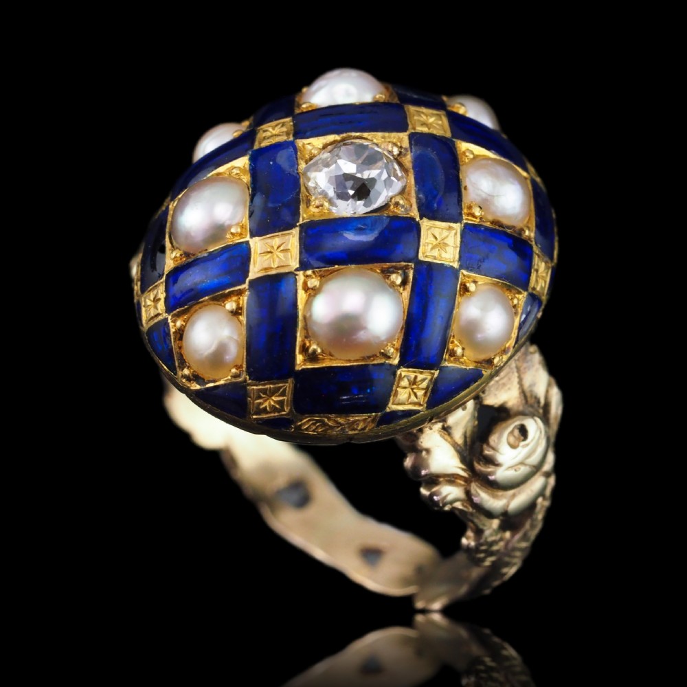 An antique Victorian 14K gold ring featuring a domed royal blue enamel lattice design accented with round pearls, star engravings, and a central diamond. View XIX