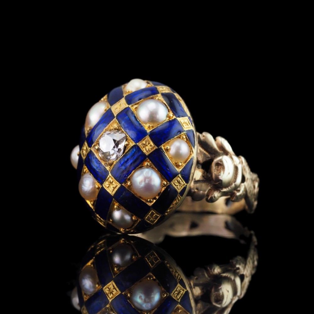 An antique Victorian 14K gold ring featuring a domed royal blue enamel lattice design accented with round pearls, star engravings, and a central diamond. View XX