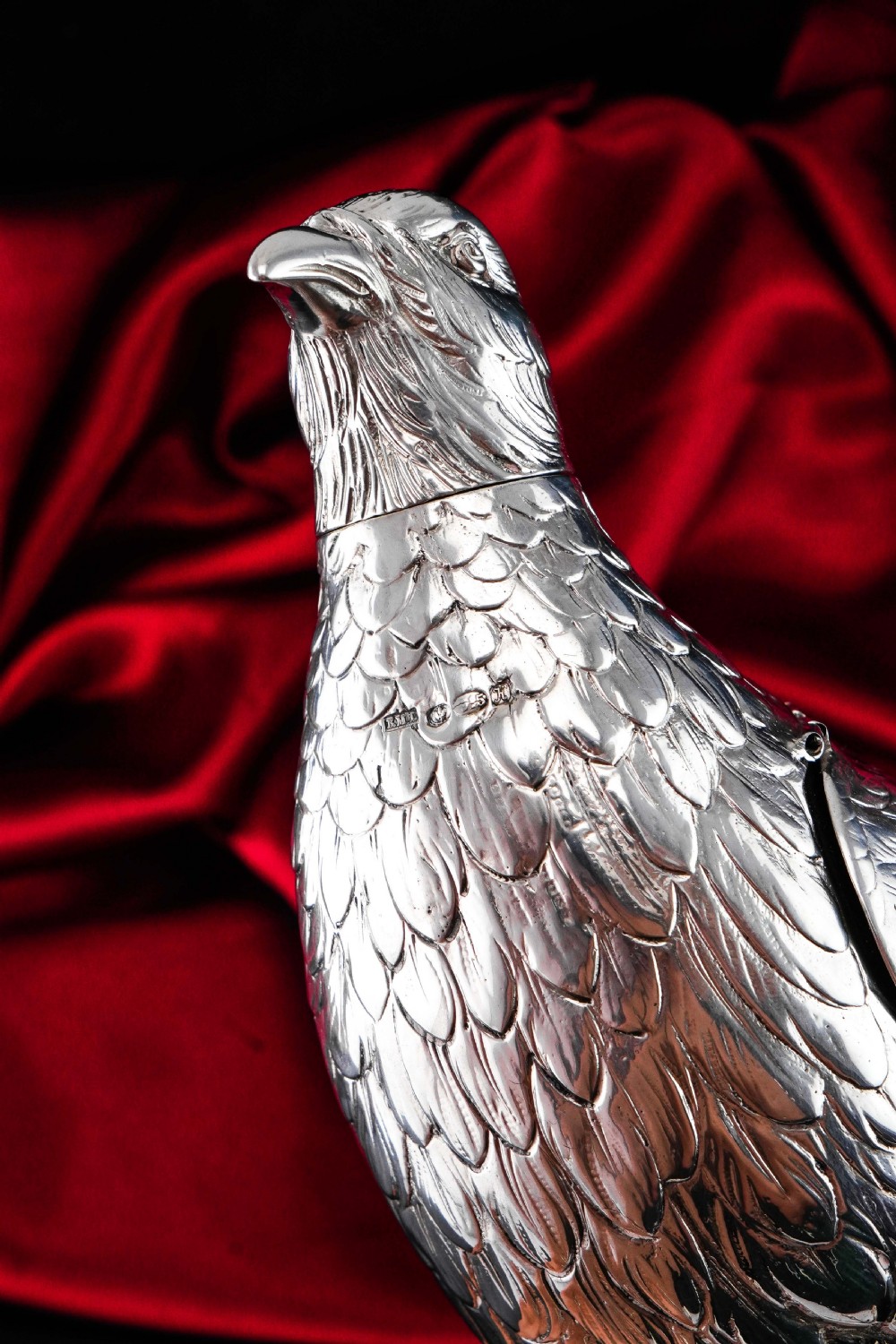 A solid silver model of a partridge with chased feather detailing standing on two feet with a hinged compartment lid along its back. View XVIII