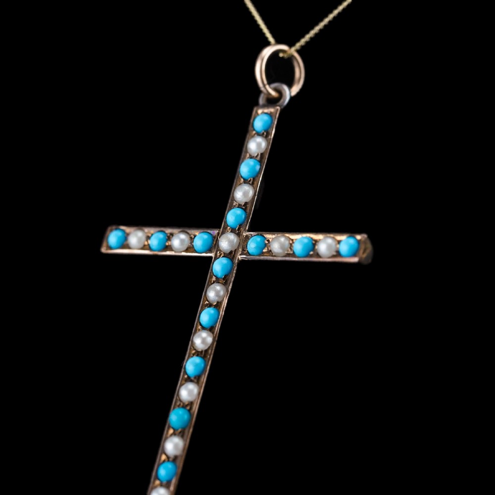 An antique 9ct gold cross pendant set with alternating blue turquoise cabochons and white seed pearls, suspended from a fine gold chain. View III