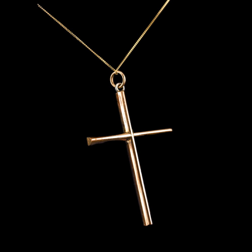 An antique 9ct gold cross pendant set with alternating blue turquoise cabochons and white seed pearls, suspended from a fine gold chain. View IV
