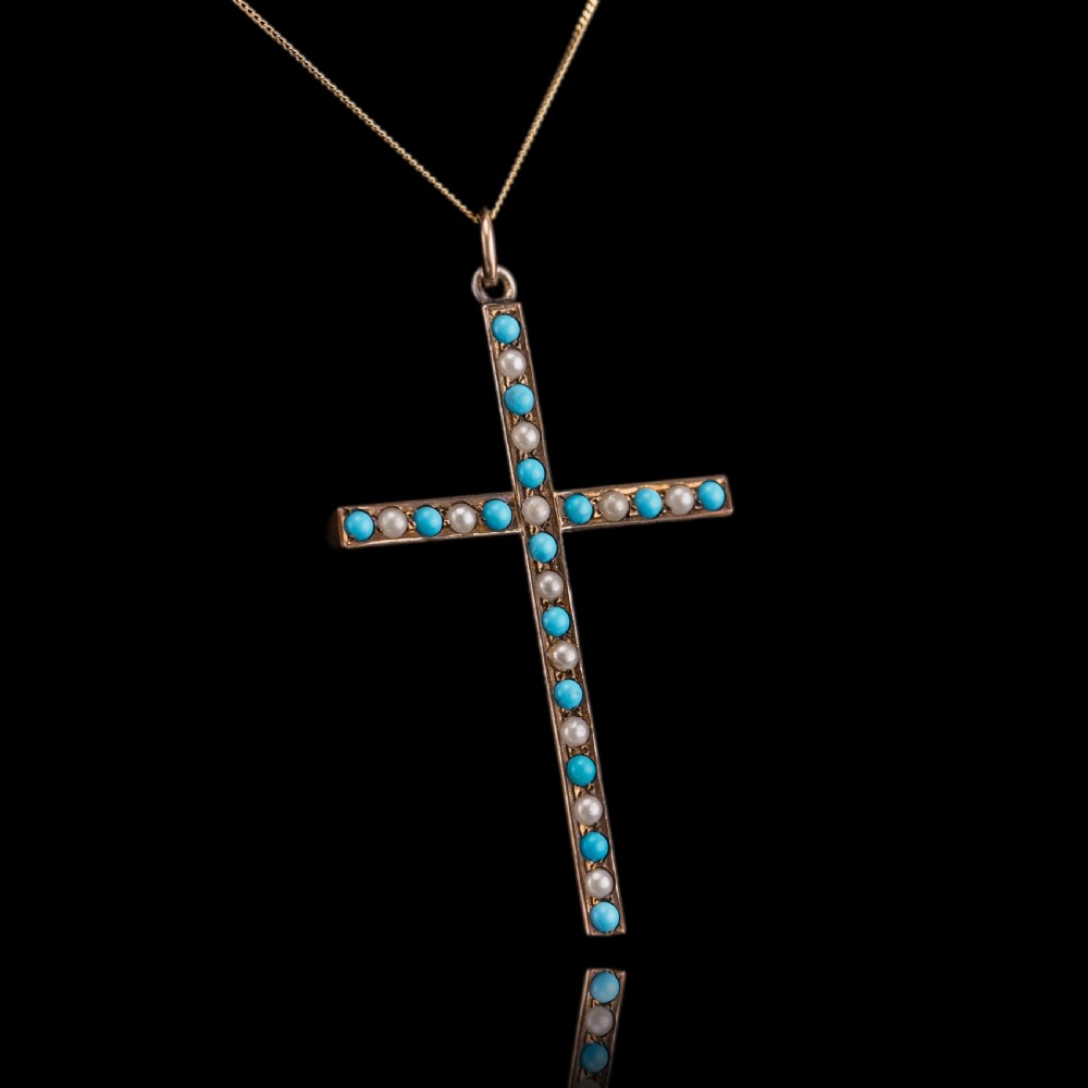 An antique 9ct gold cross pendant set with alternating blue turquoise cabochons and white seed pearls, suspended from a fine gold chain. View XI