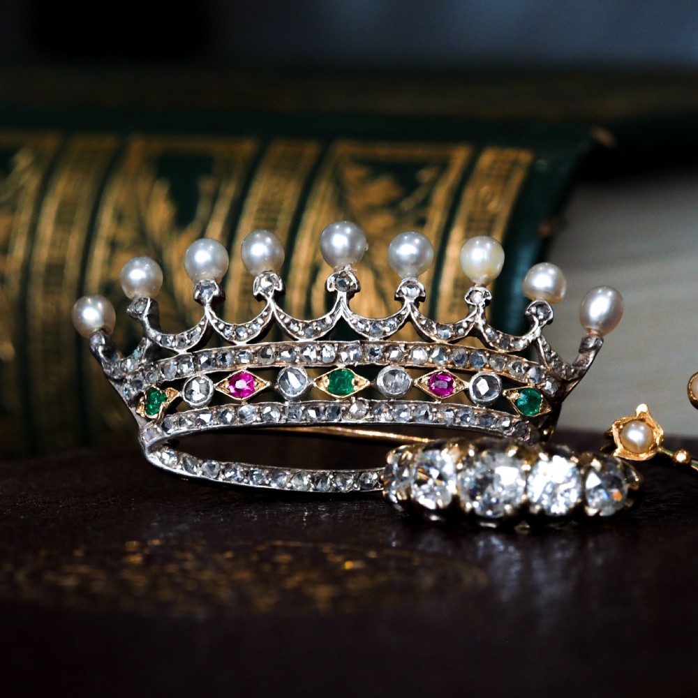 An antique French coronet brooch crafted in 18K gold and silver, encrusted with diamonds, rubies, emeralds, and topped with nine pearls. View III