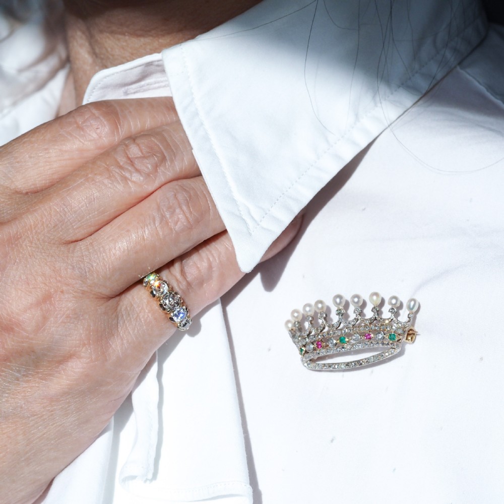 An antique French coronet brooch crafted in 18K gold and silver, encrusted with diamonds, rubies, emeralds, and topped with nine pearls. View VIII