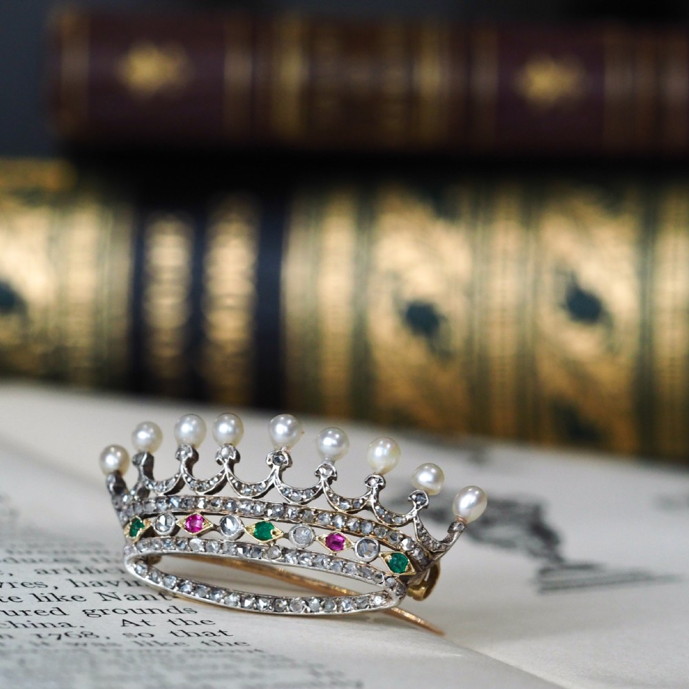 An antique French coronet brooch crafted in 18K gold and silver, encrusted with diamonds, rubies, emeralds, and topped with nine pearls. View XII
