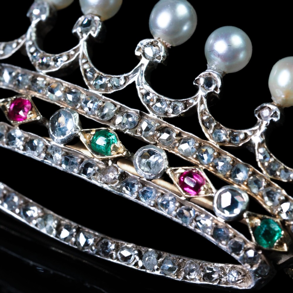 An antique French coronet brooch crafted in 18K gold and silver, encrusted with diamonds, rubies, emeralds, and topped with nine pearls. View XIII