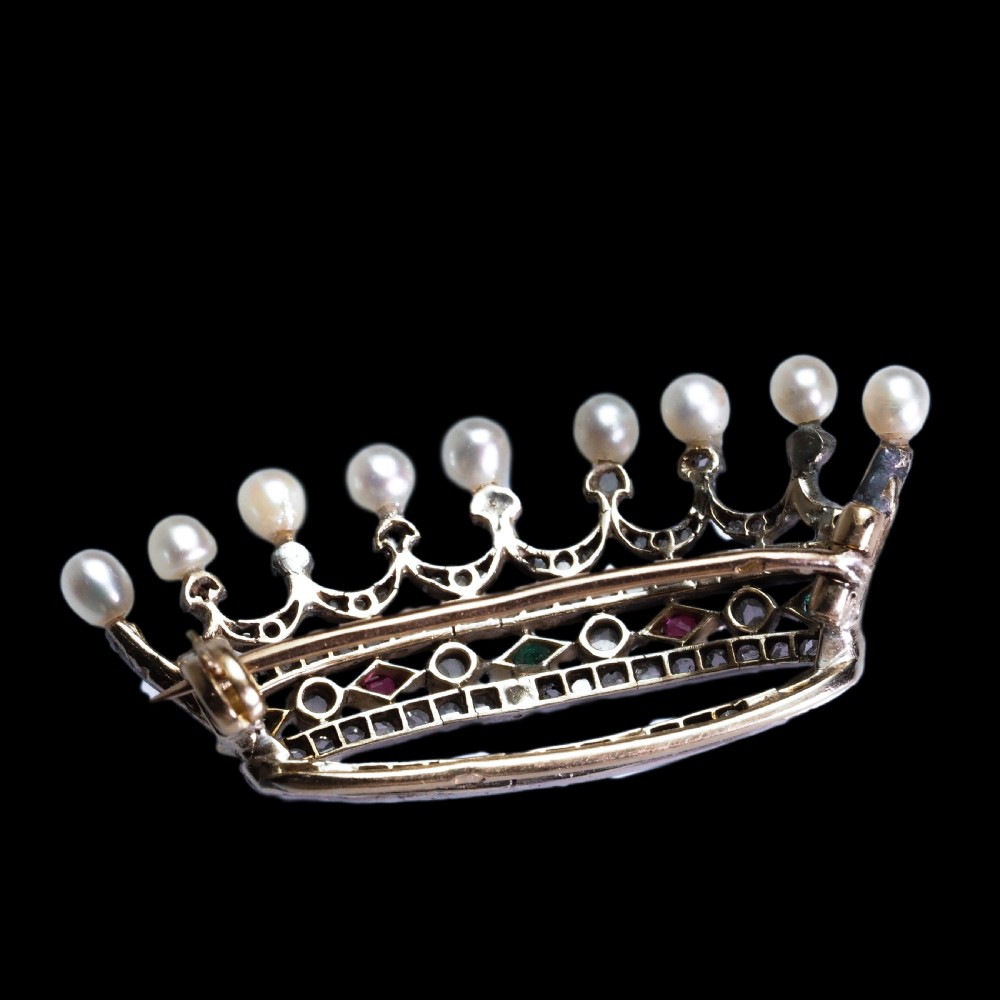 An antique French coronet brooch crafted in 18K gold and silver, encrusted with diamonds, rubies, emeralds, and topped with nine pearls. View XVII