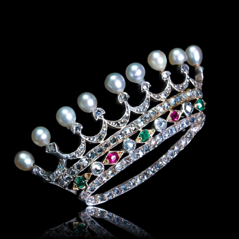 An antique French coronet brooch crafted in 18K gold and silver, encrusted with diamonds, rubies, emeralds, and topped with nine pearls. View XXI