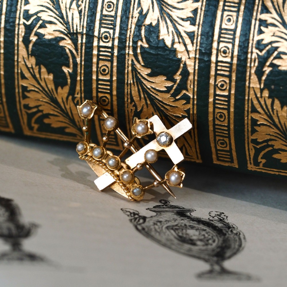 A late Victorian 15-carat gold coronet brooch set with natural pearls and a central cross motif adorned with a single diamond. View VIII