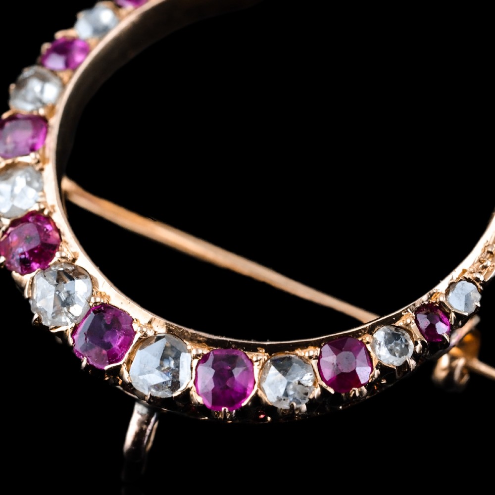 An 18K gold Victorian crescent moon brooch set with alternating cushion-cut rubies and old-cut diamonds. View III