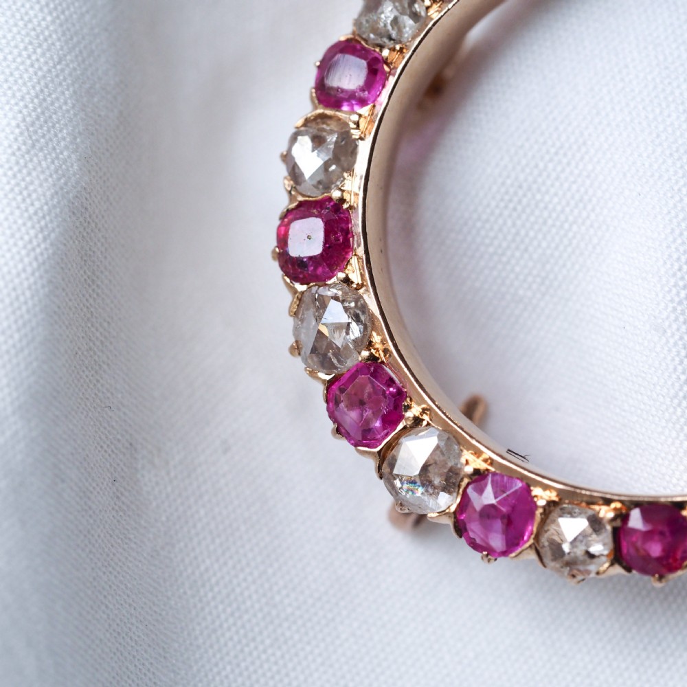 An 18K gold Victorian crescent moon brooch set with alternating cushion-cut rubies and old-cut diamonds. View VI