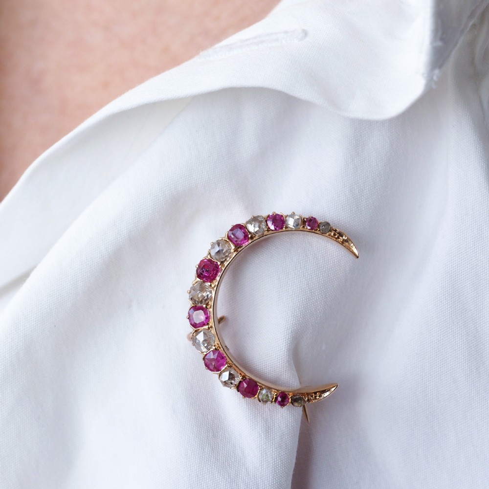 An 18K gold Victorian crescent moon brooch set with alternating cushion-cut rubies and old-cut diamonds. View VII