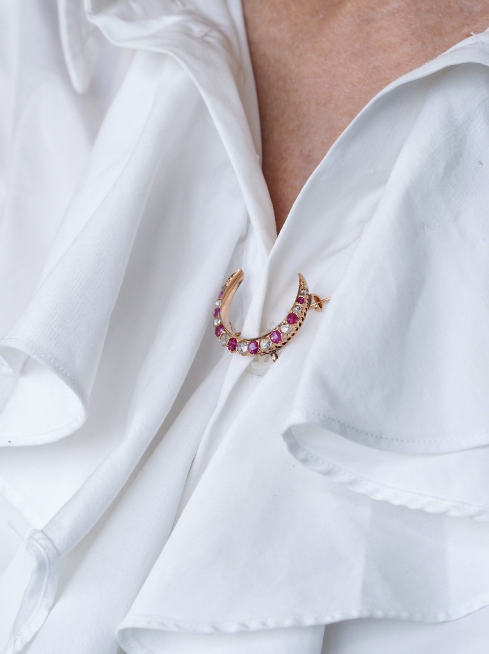 An 18K gold Victorian crescent moon brooch set with alternating cushion-cut rubies and old-cut diamonds. View XI