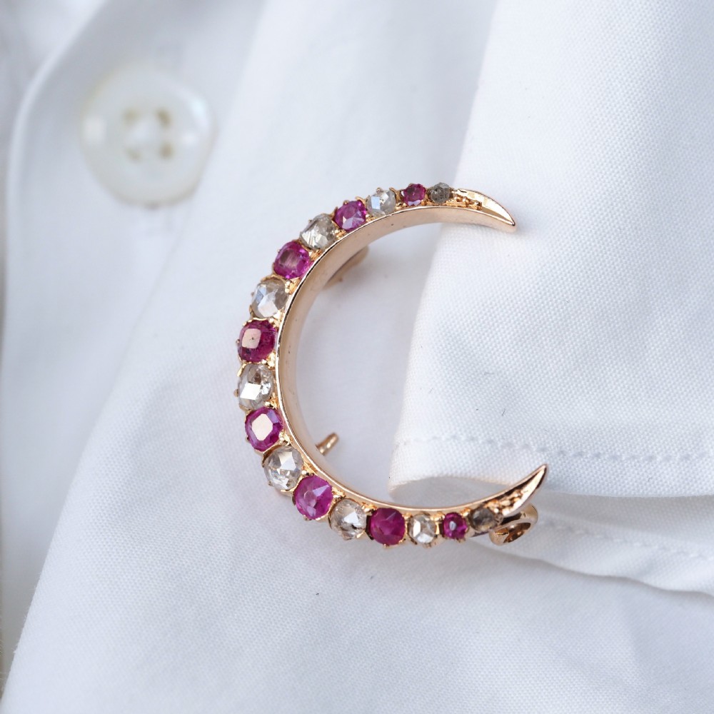 An 18K gold Victorian crescent moon brooch set with alternating cushion-cut rubies and old-cut diamonds. View XIV
