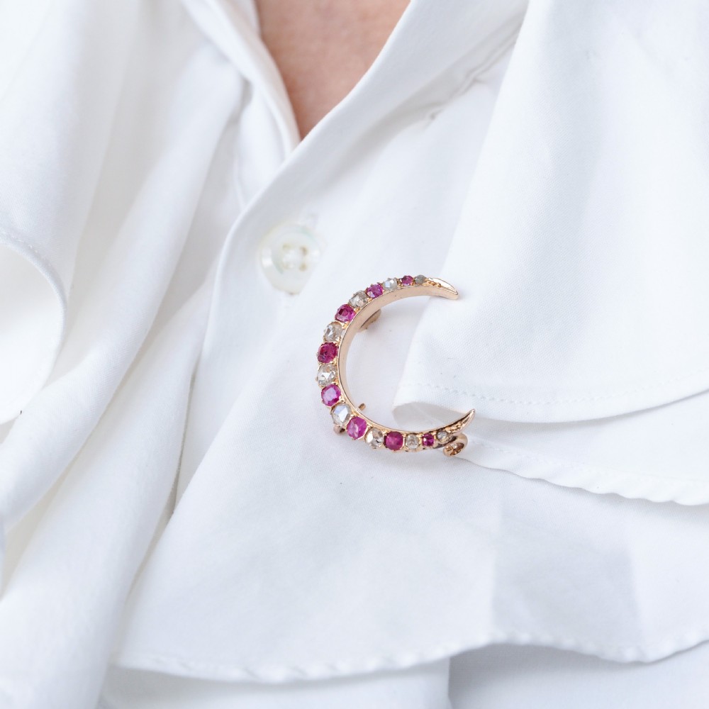 An 18K gold Victorian crescent moon brooch set with alternating cushion-cut rubies and old-cut diamonds. View XV