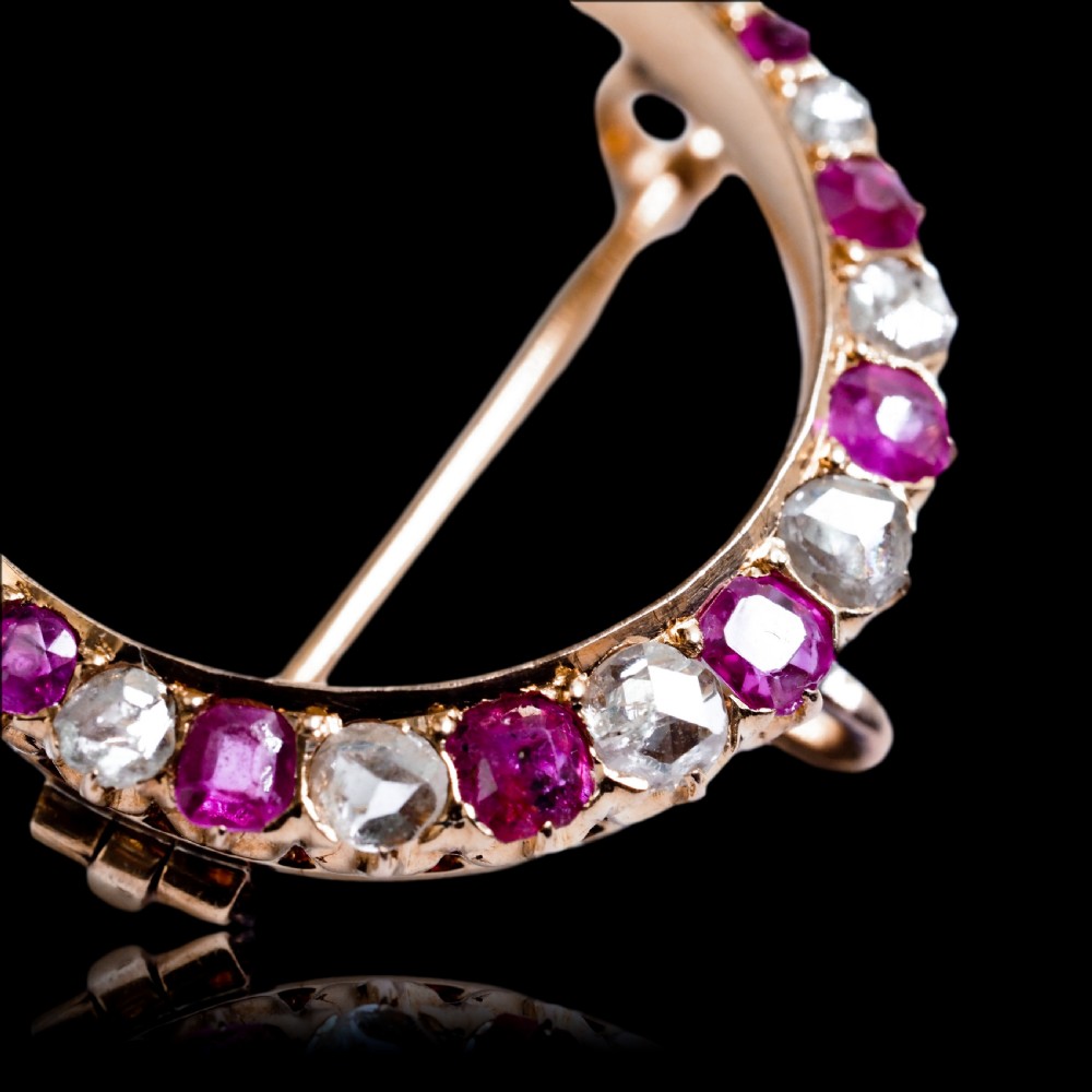 An 18K gold Victorian crescent moon brooch set with alternating cushion-cut rubies and old-cut diamonds. View XVI