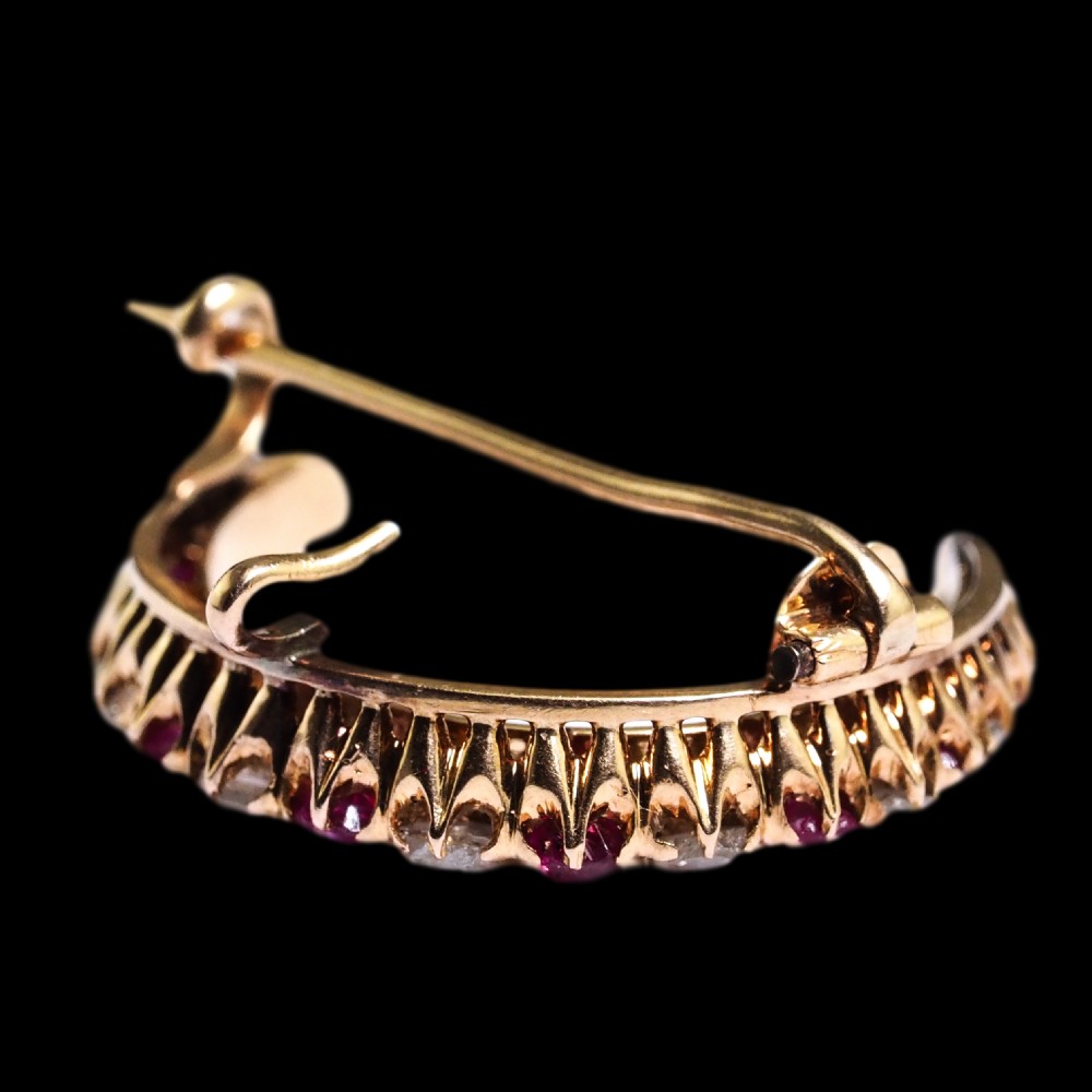 An 18K gold Victorian crescent moon brooch set with alternating cushion-cut rubies and old-cut diamonds. View XIX