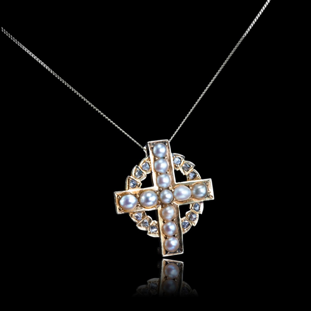 An antique 15K yellow gold Celtic cross brooch and pendant set with central pearls along the arms and diamonds set within the circular halo. View XIV