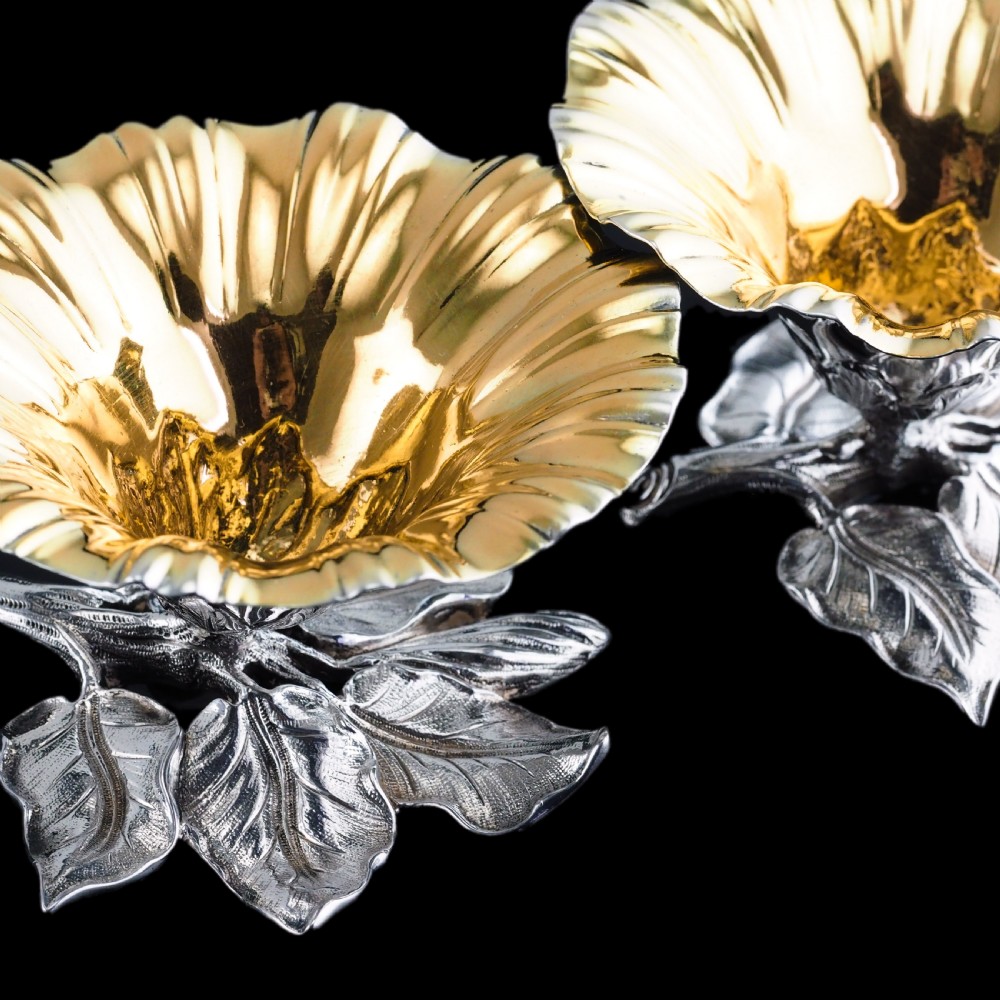 A pair of William IV sterling silver salt cellars designed as open flower heads with gilded interiors resting on naturalistic leaf bases. View XIII