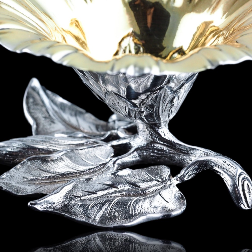 A pair of William IV sterling silver salt cellars designed as open flower heads with gilded interiors resting on naturalistic leaf bases. View XVII