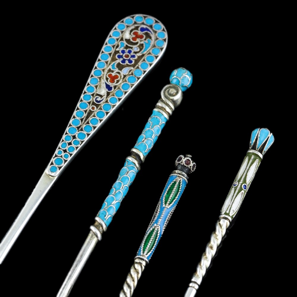 A four-piece set of late 19th-century Russian silver and cloisonne enamel cutlery featuring three spoons and a fork with turquoise blue, white, and red floral motifs. View III