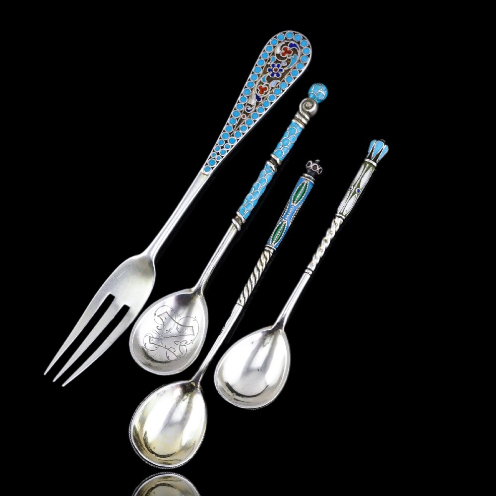A four-piece set of late 19th-century Russian silver and cloisonne enamel cutlery featuring three spoons and a fork with turquoise blue, white, and red floral motifs. View IV