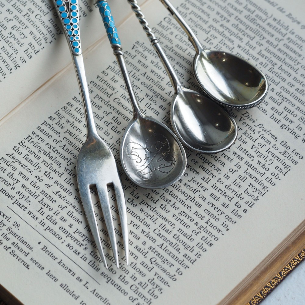 A four-piece set of late 19th-century Russian silver and cloisonne enamel cutlery featuring three spoons and a fork with turquoise blue, white, and red floral motifs. View VIII